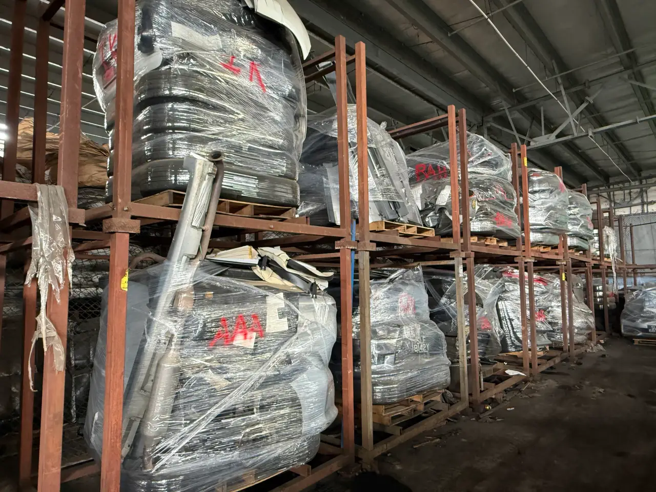 Wrapped vehicle front sections stored on racks at Everise Auto